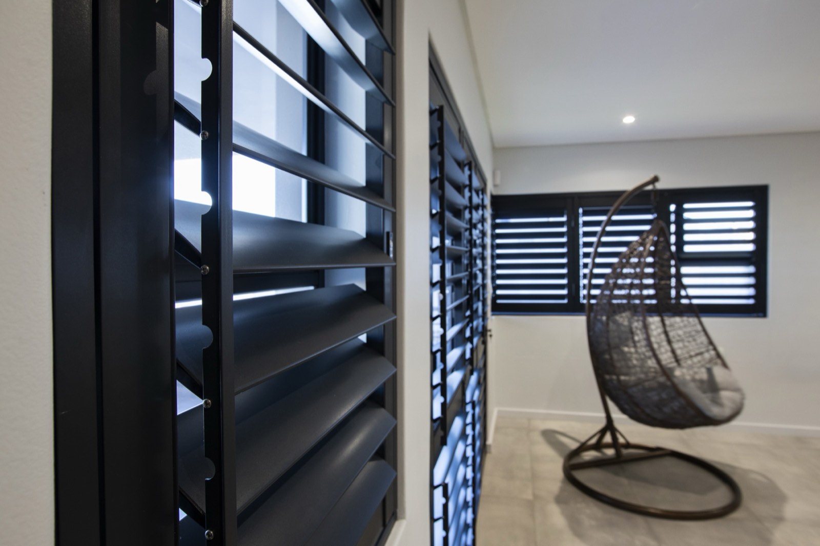 Matte black aluminium security shutters with adjustable blades