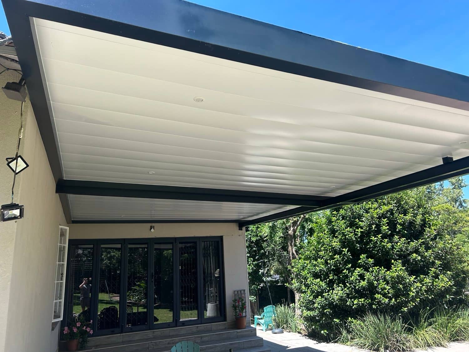 White ceiling awning panels with downlights under a charcoal fascia on a Gauteng patio