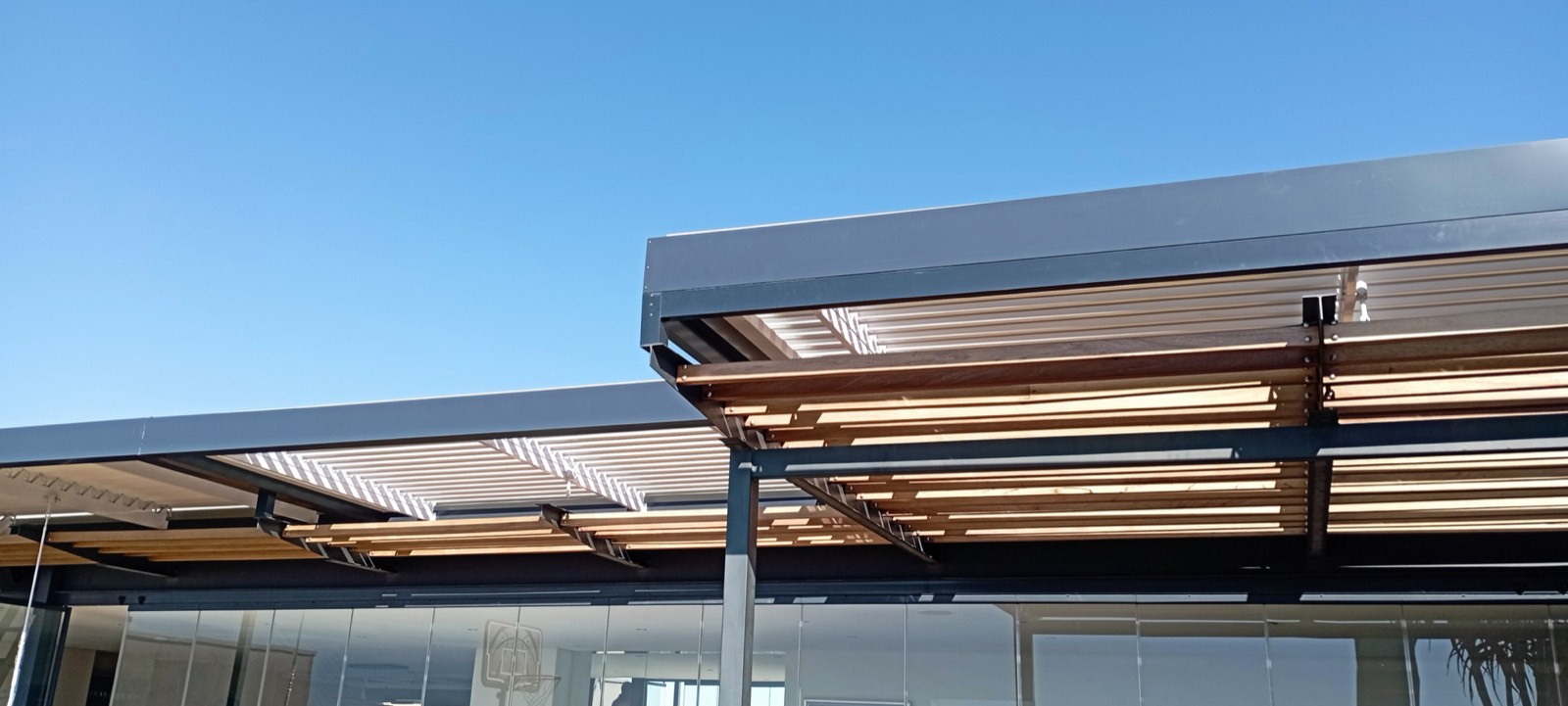 Charcoal louvre awning and timber pergola on a modern Gauteng home
