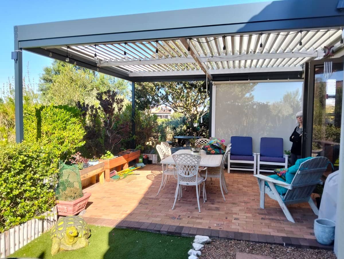 Outdoor roller blinds sealing a Winelands veranda in Stellenbosch