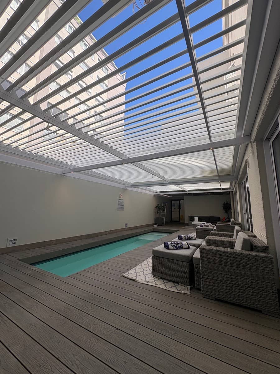 Louvre awning over a spa pool courtyard in Sea Point
