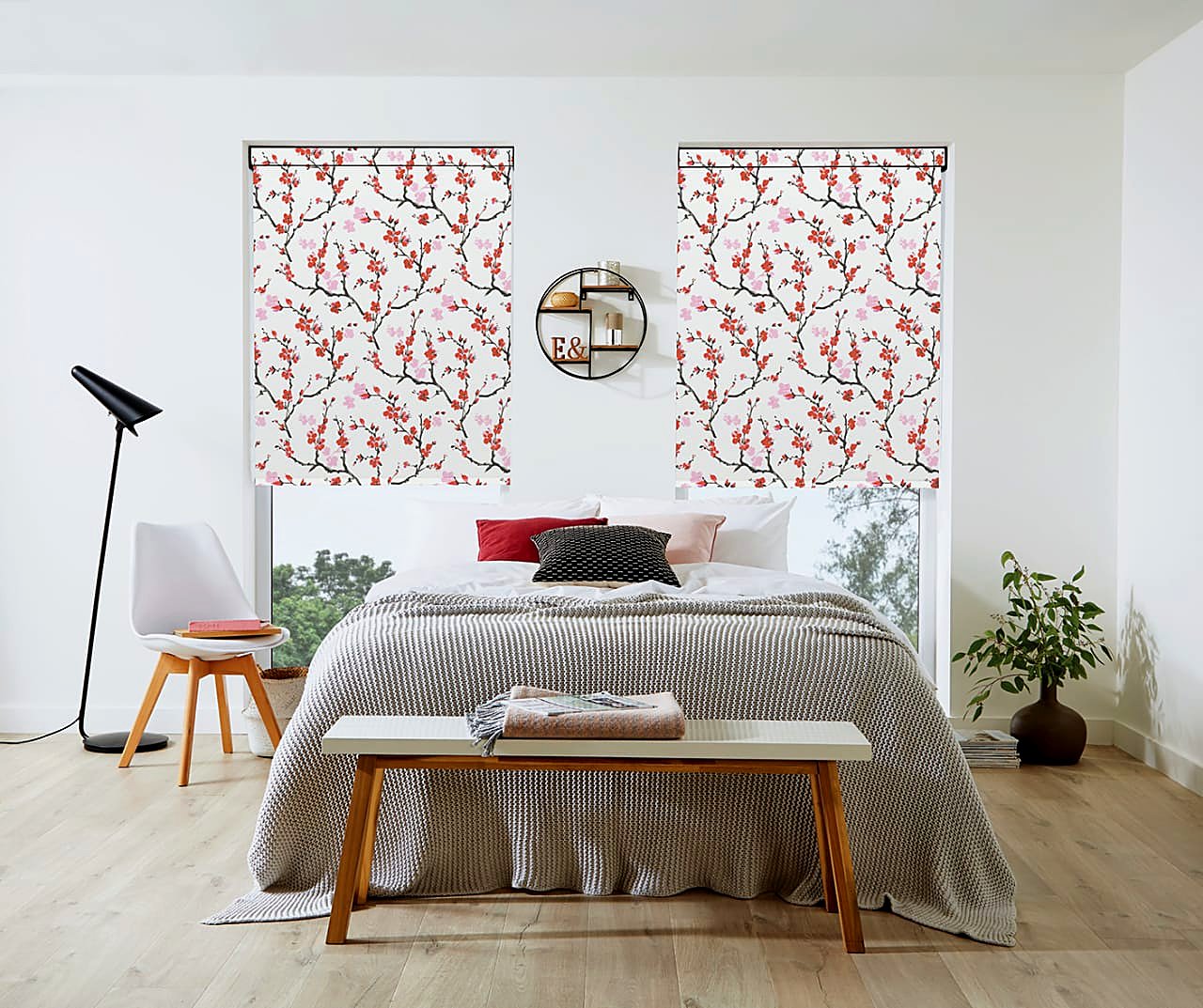 Blossom-print roller blinds in a styled guest bedroom